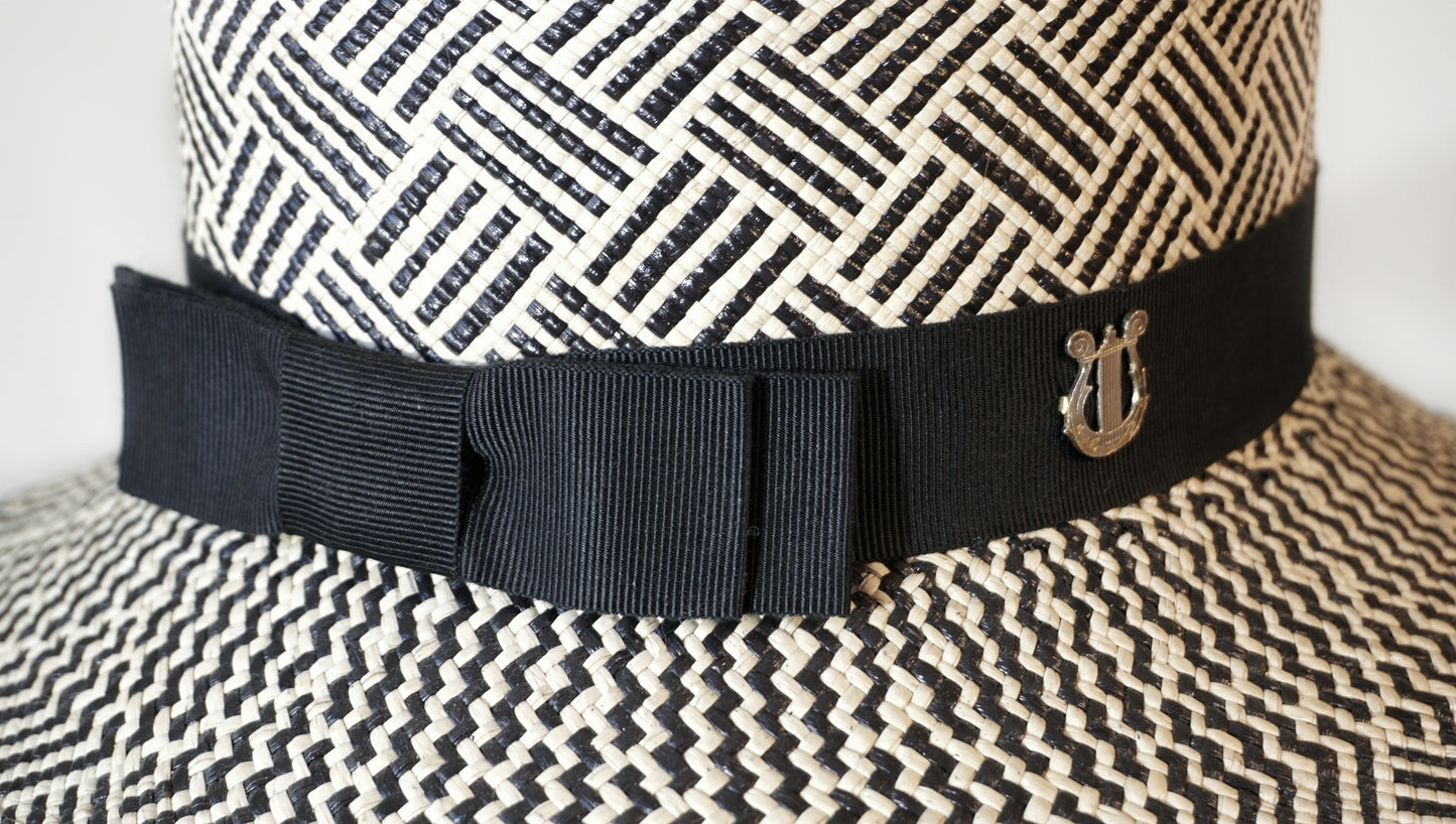 Leto Ode pale cream and black boater hat in Panama straw by Anna Xaniotaki - close-up detail of double black bow and sterling silver lyre