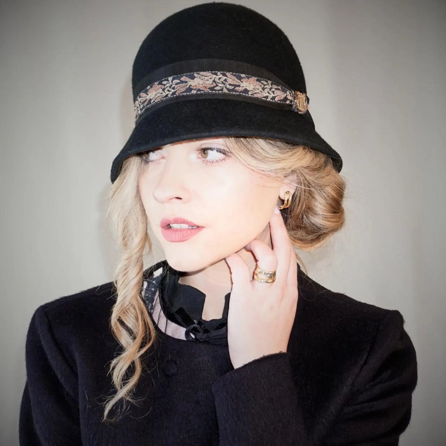 The Cloche Edit. Couture cloche hats for race days, weddings and everyday elegance by Anna Xaniotaki. Meet the Vintage Whisper Cloche in black wool felt with gold lyre jewel.