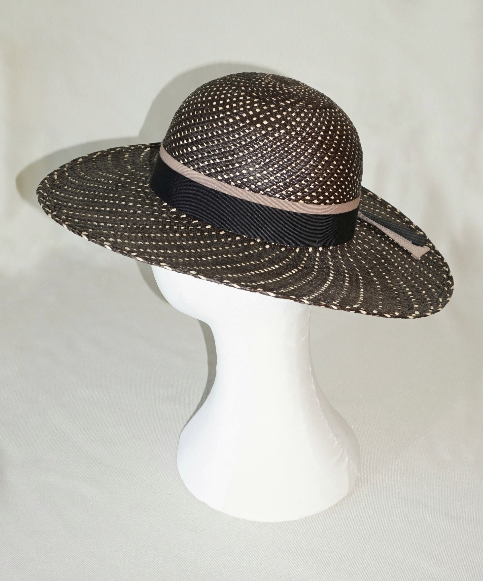 Black and ivory Panama hat with black and nude blush ribbons and gold lyre, left side view by Anna Xaniotaki