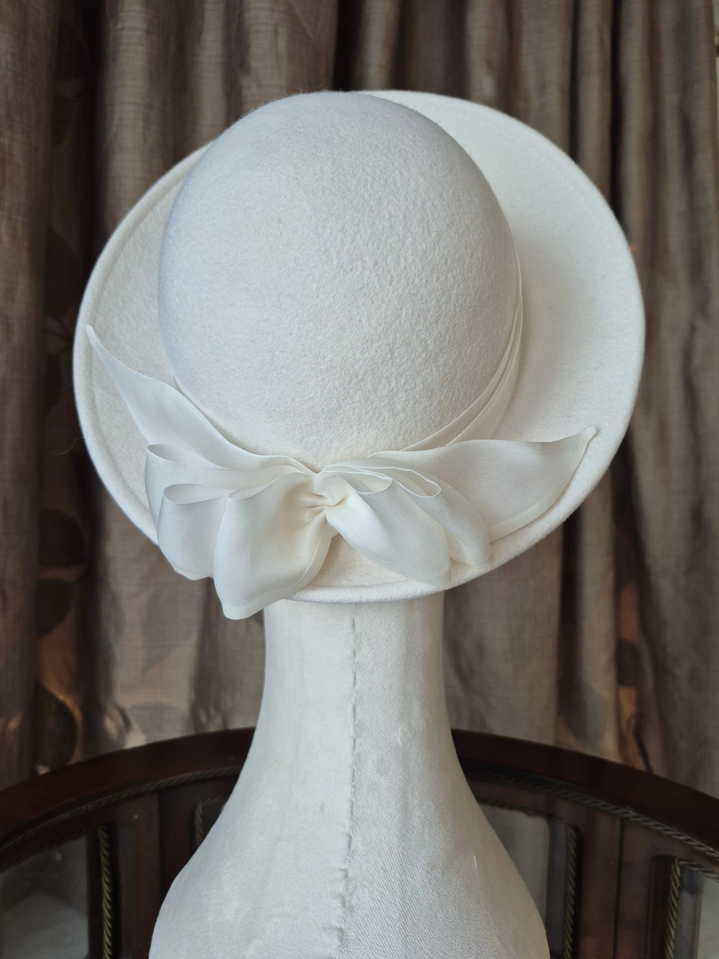 Ivory felt halo hat with silk organza bow by Anna Xaniotaki, back view by Anna Xaniotaki