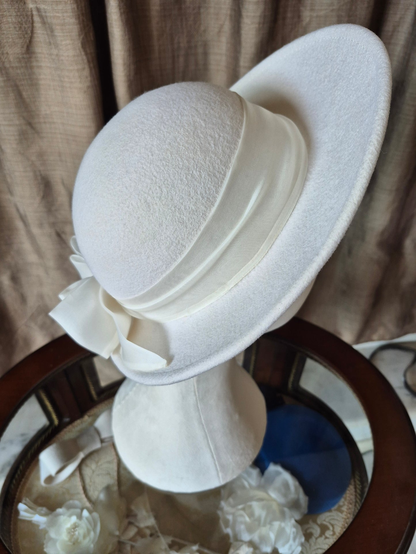Ivory felt halo hat with silk organza bow by Anna Xaniotaki, right side view by Anna Xaniotaki