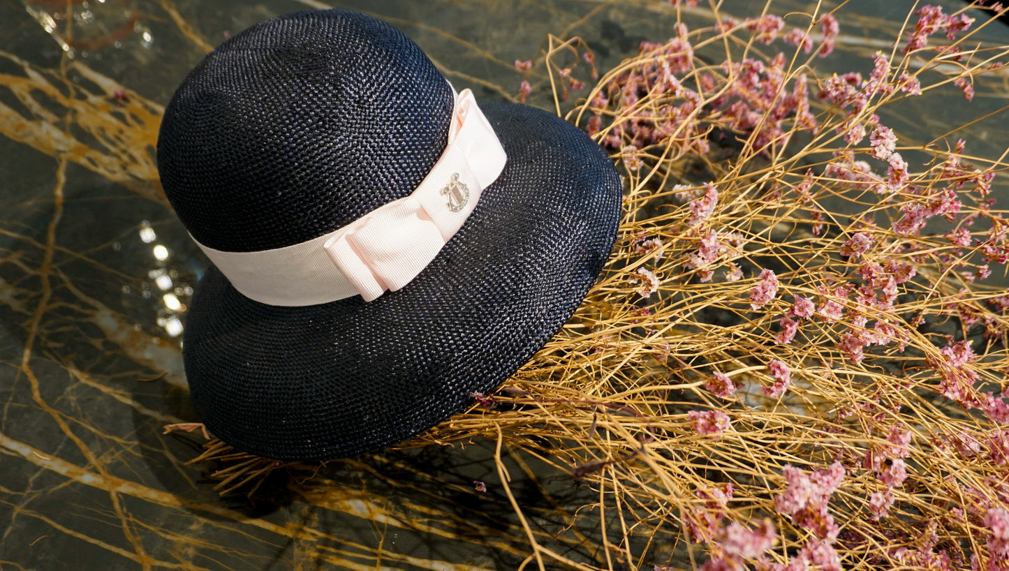 Isioni Ode navy blue viscose straw hat with pink double bow and sterling silver lyre detail by Anna Xaniotaki - back view
