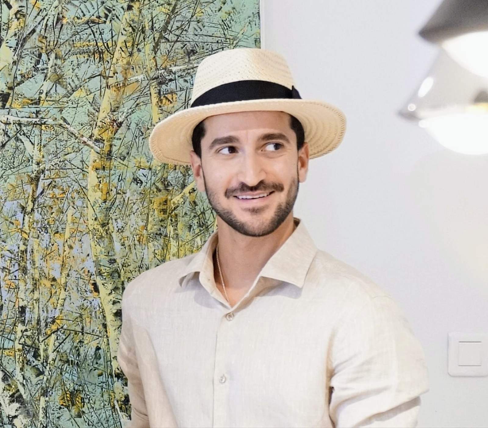 Man wearing the André fedora straw hat in ivory with black Italian cotton grosgrain band front view. Custom made-to-order fedora for summer special occasions, garden parties, vacations or for everyday man's elegance. Bespoke couture millinery by Anna Xaniotaki