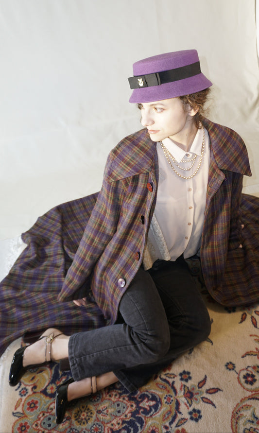 Aristocratic Melody Pillbox Hat in Royal Purple Wool Felt with Black Double Bow and Gold Lyre by Anna Xaniotaki - left side view