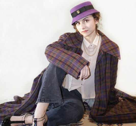 Aristocratic Melody Pillbox Hat in Royal Purple Wool Felt with Black Double Bow and Gold Lyre by Anna Xaniotaki - front view