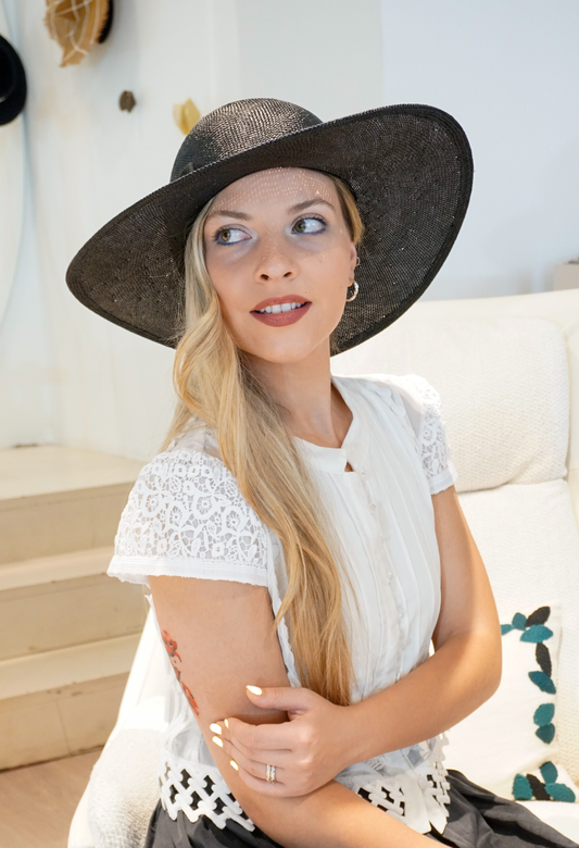 Auréole Élégante in Black Visca Straw with a Gold Lyre & an Elegant Bow by Anna Xaniotaki front view