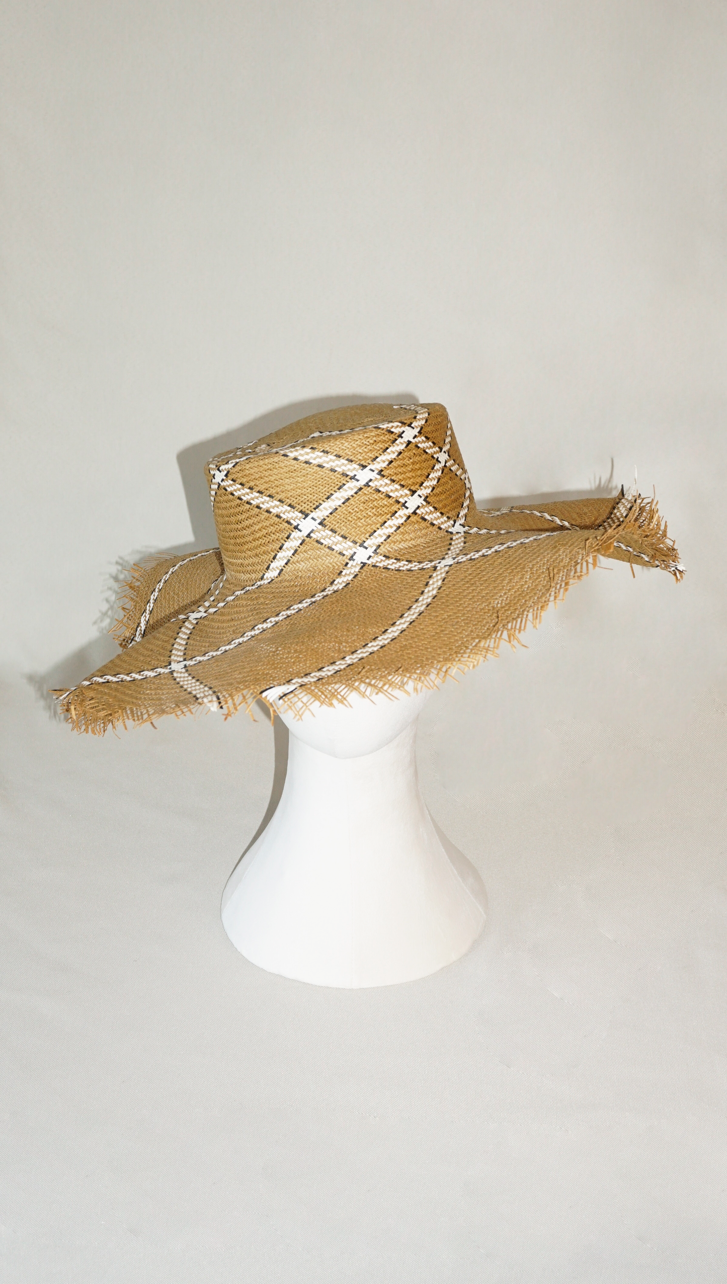 Aura hand-woven wide brim hat, golden chestnut Toyo paper straw, ivory & black geometric plaid, bohemian sculptural presence, front view by Anna Xaniotaki