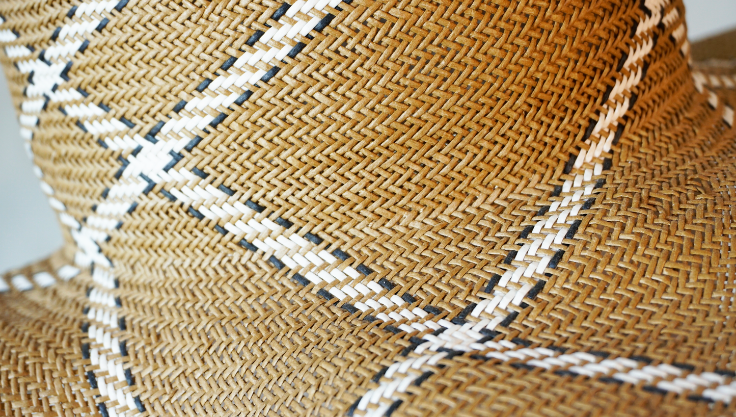 Aura hand-woven wide brim hat, golden chestnut Toyo paper straw texture detail, ivory & black geometric plaid, hand-woven weave close-up by Anna Xaniotaki
