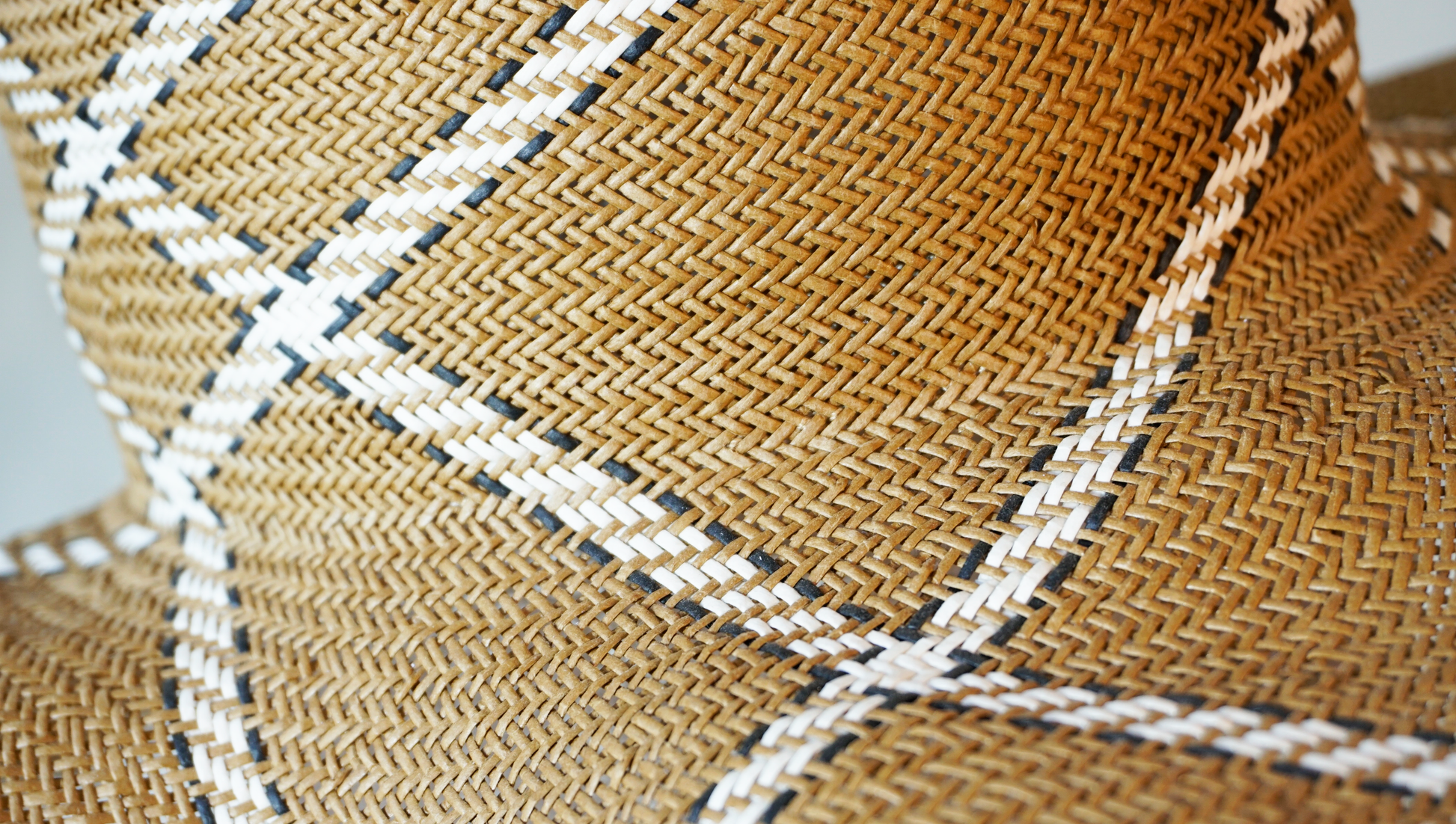 Aura hand-woven wide brim hat, golden chestnut Toyo paper straw texture detail, ivory & black geometric plaid, hand-woven weave close-up by Anna Xaniotaki