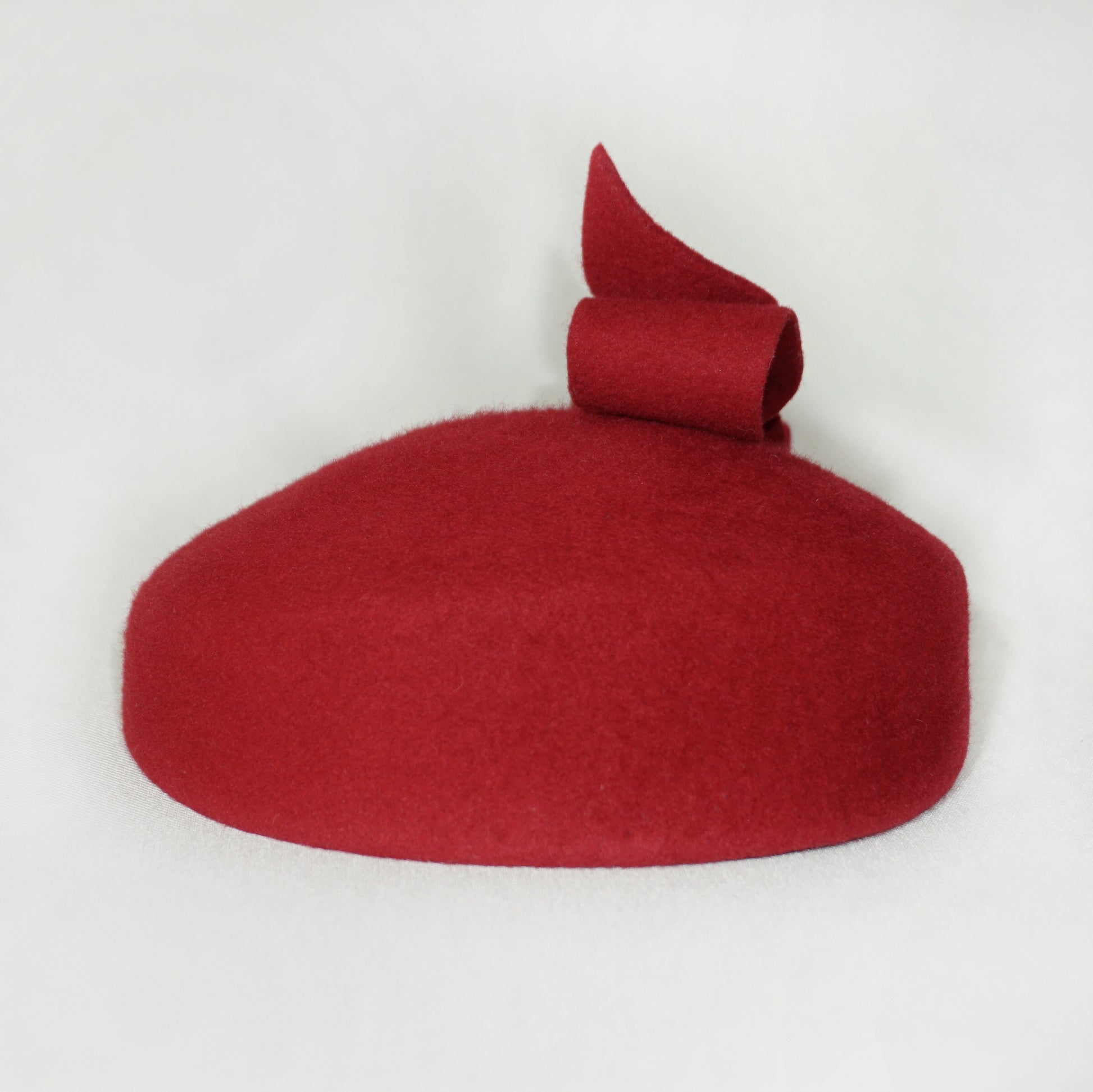 Erato Ode red pillbox hat by Anna Xaniotaki, left view