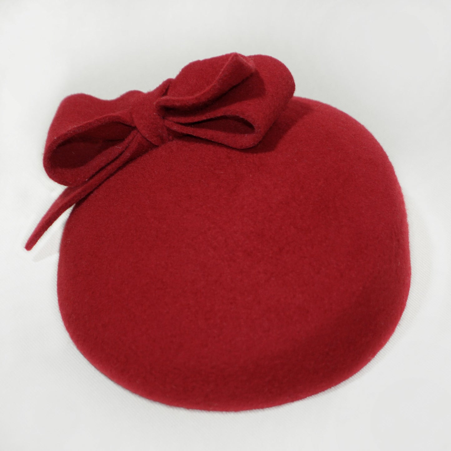 Bow detail on Erato Ode red pillbox hat by Anna Xaniotaki