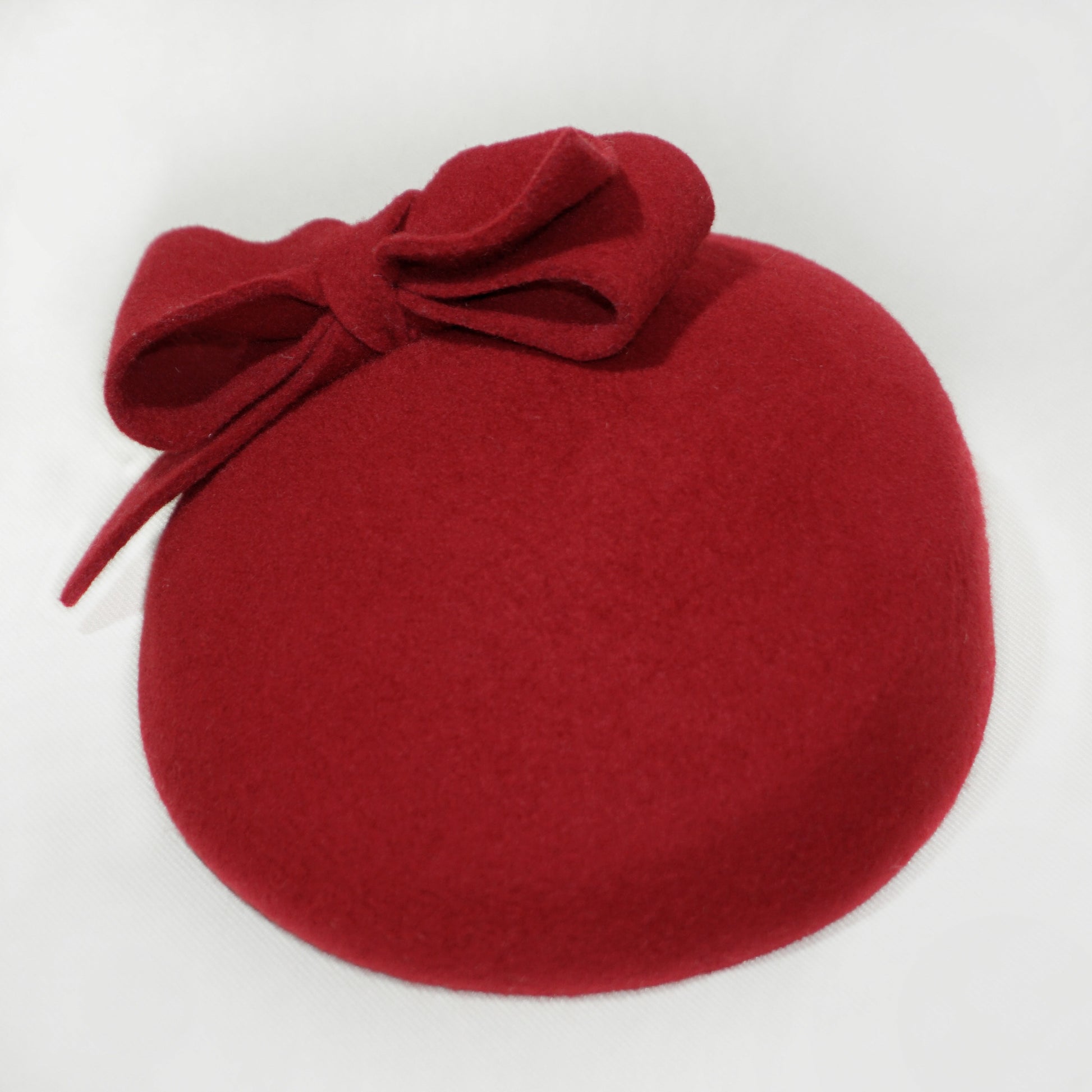 Bow detail on Erato Ode red pillbox hat by Anna Xaniotaki
