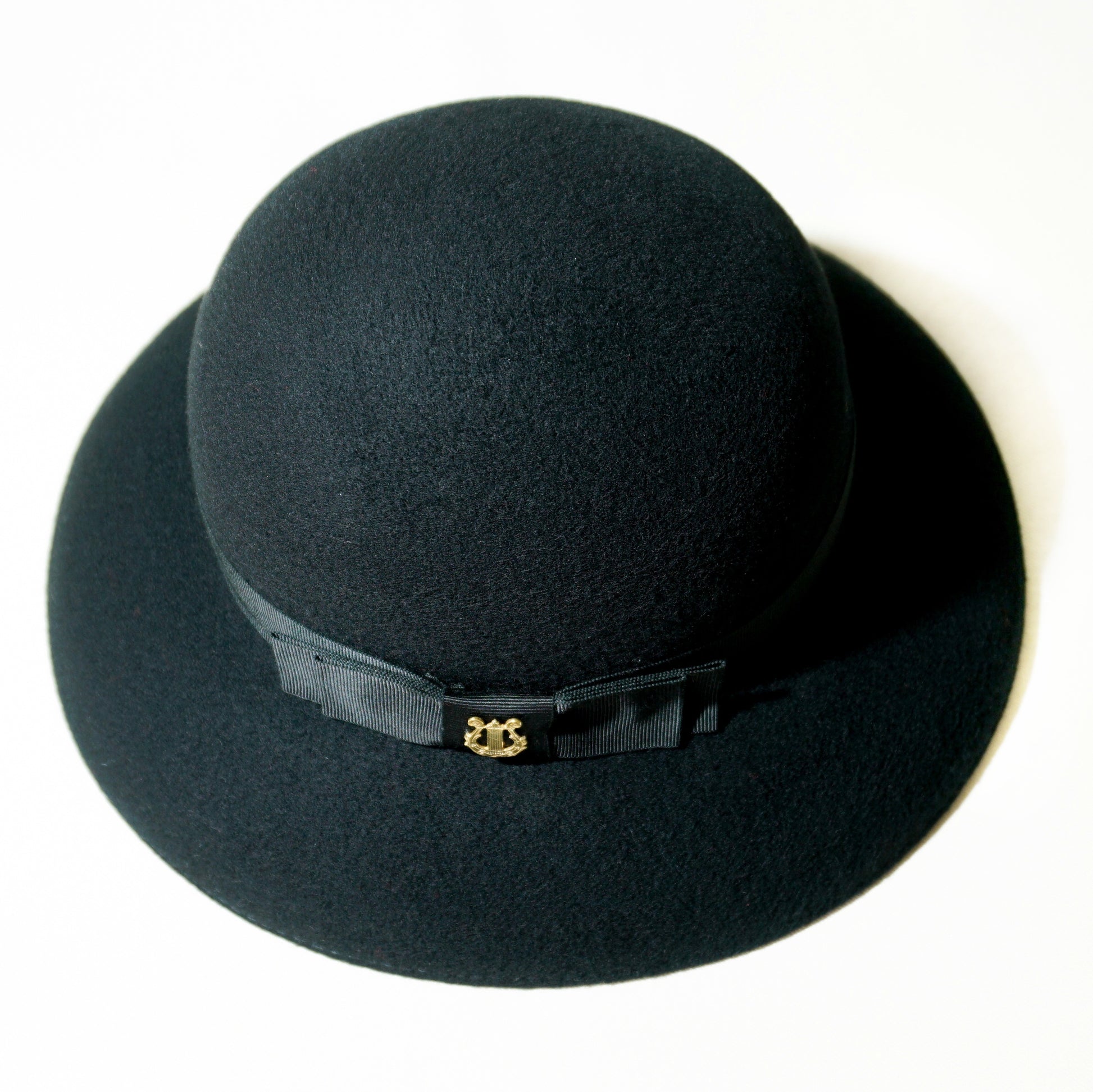 Noir Elegance Hat in Wool Felt with Bow and Gold Lyre by Anna Xaniotaki - top side view