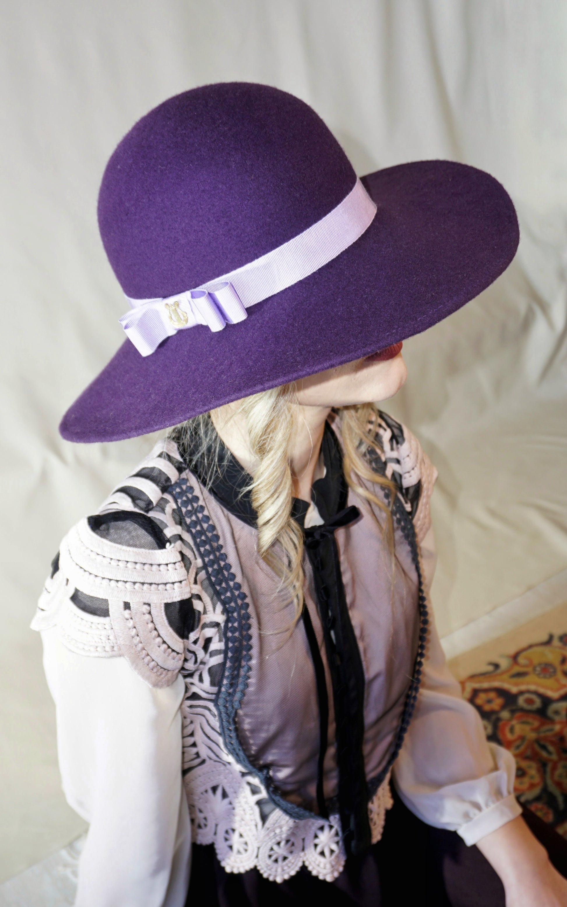 La Violette Nocturne Orchid Purple Felt Hat with Lavender Purple Double Bow & Gold Lyre by Anna Xaniotaki - three-quarter view