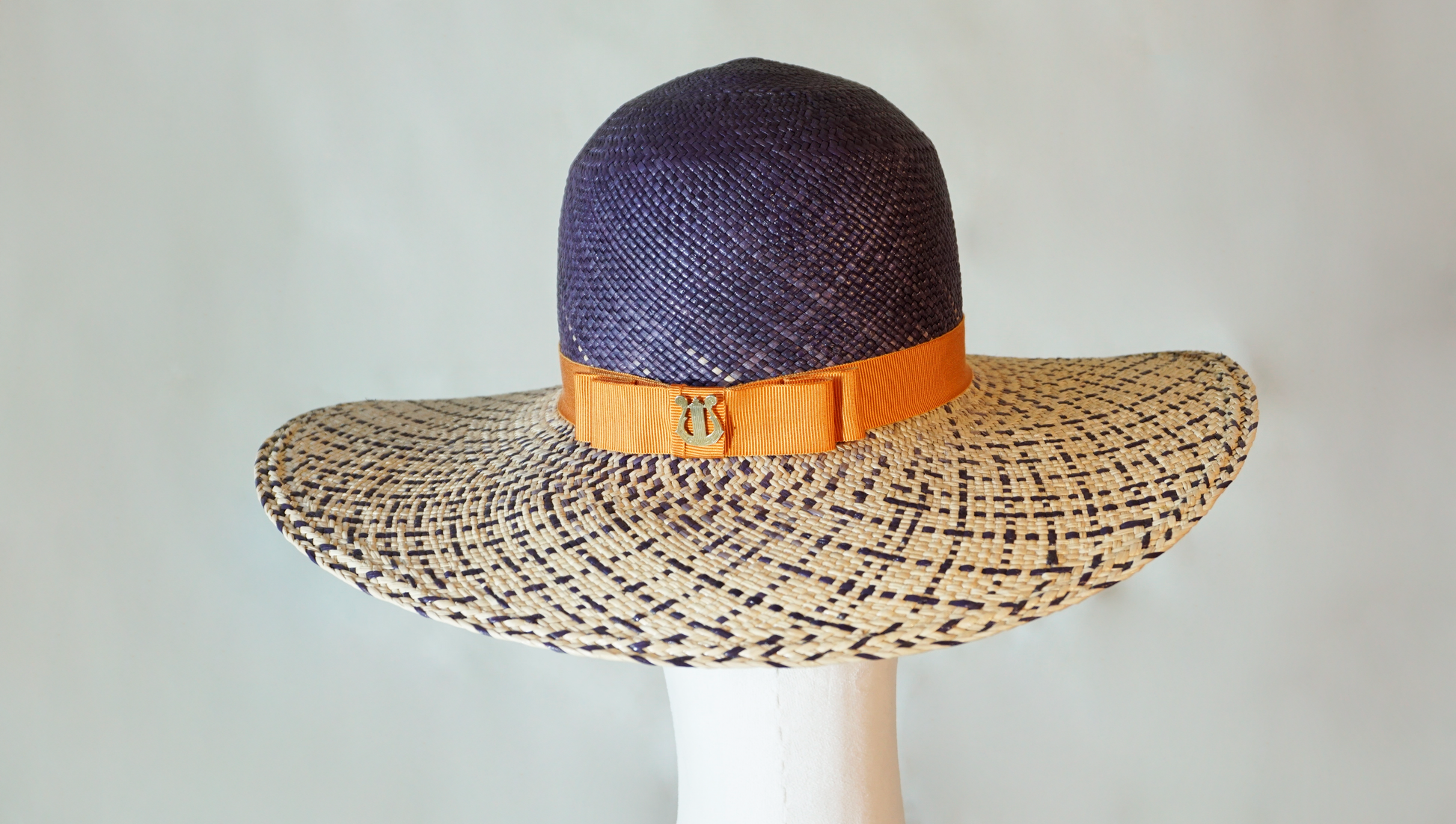 Lyra Soleil Panama Straw Hat in Navy, Natural & Gold Lyre by Anna Xaniotaki, back view