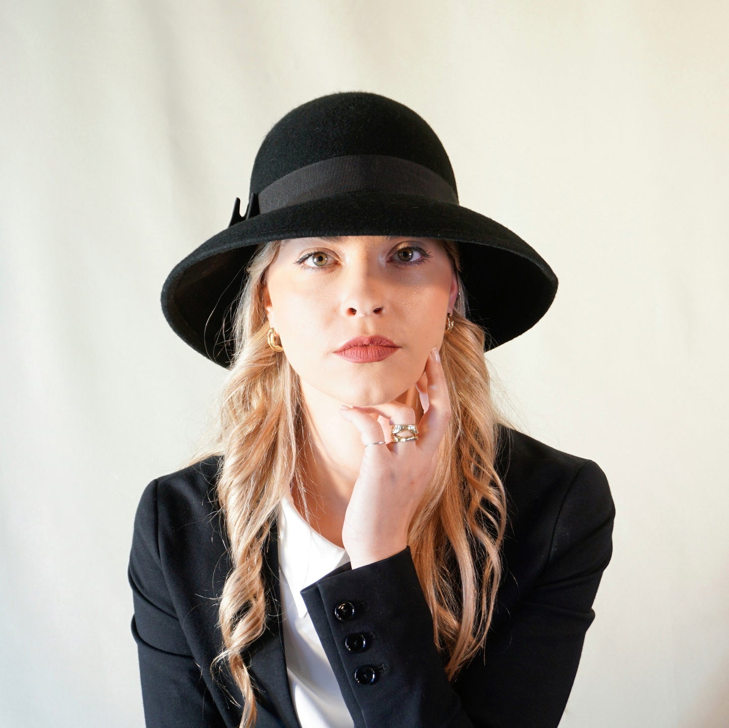 Noir Elegance Hat in Wool Felt with Bow and Gold Lyre by Anna Xaniotaki - front view
