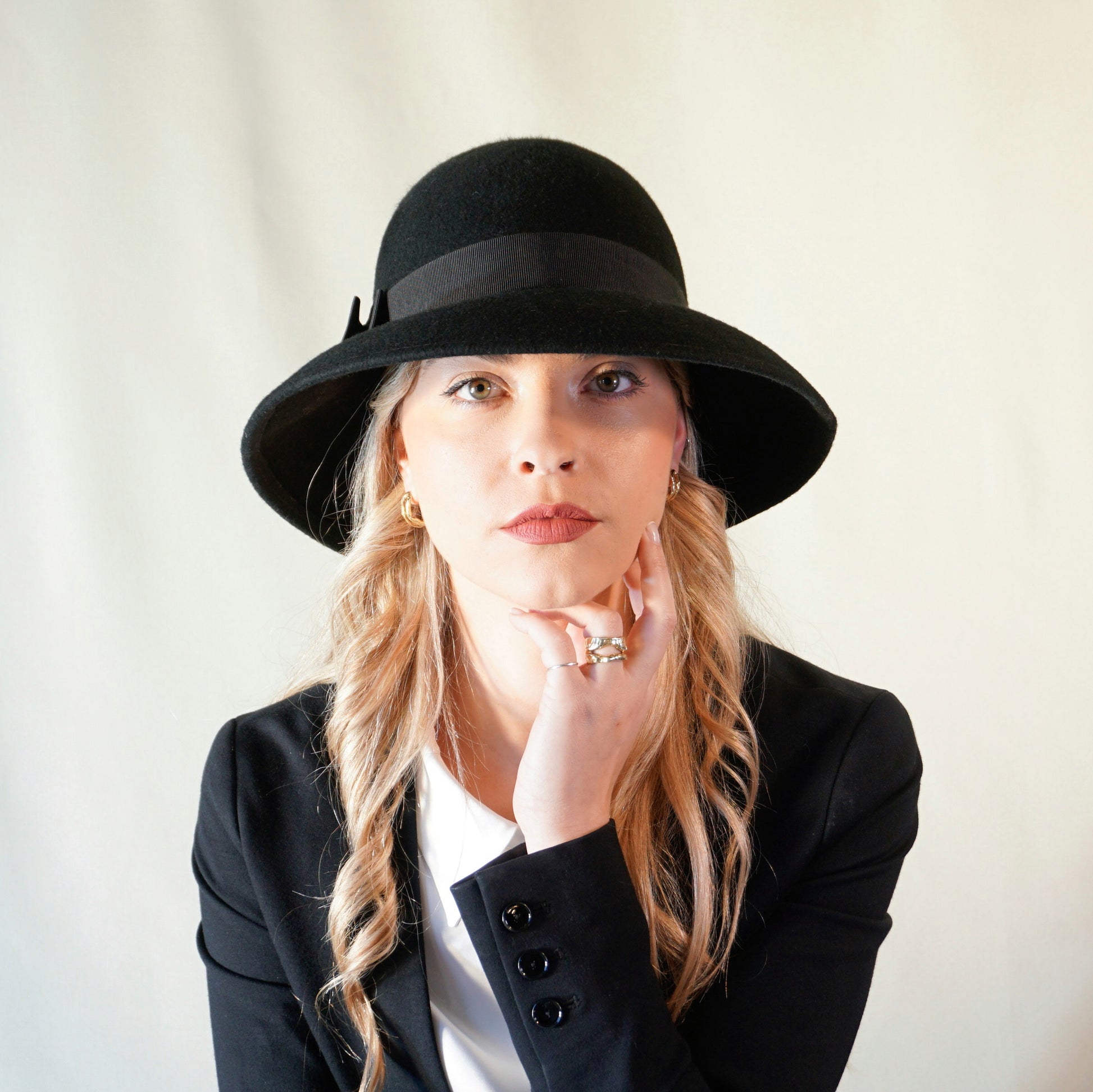Noir Elegance Hat in Wool Felt with Bow and Gold Lyre by Anna Xaniotaki - front view