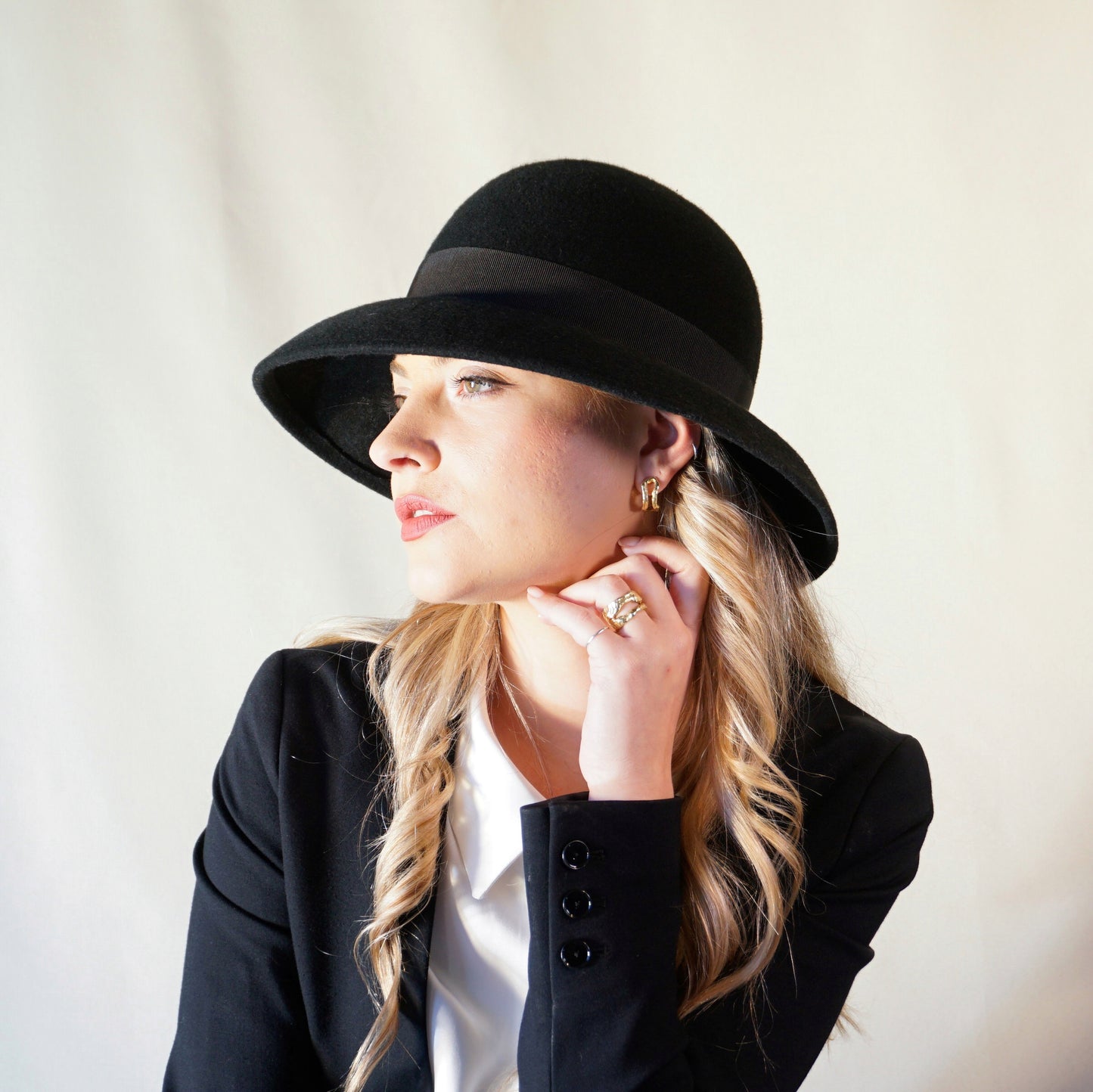 Noir Elegance Hat in Wool Felt with Bow and Gold Lyre by Anna Xaniotaki -left sideview