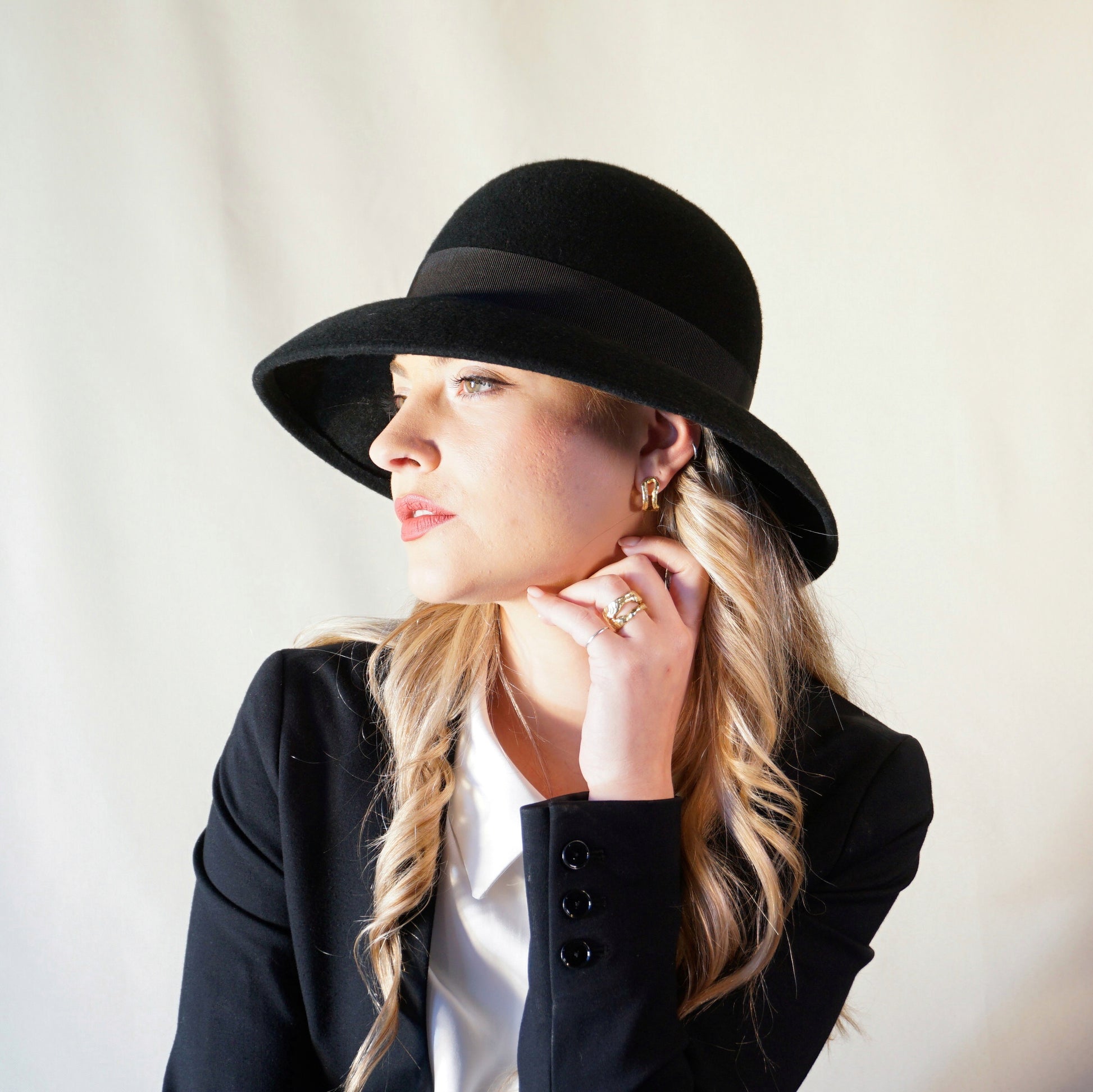 Noir Elegance Hat in Wool Felt with Bow and Gold Lyre by Anna Xaniotaki -left sideview