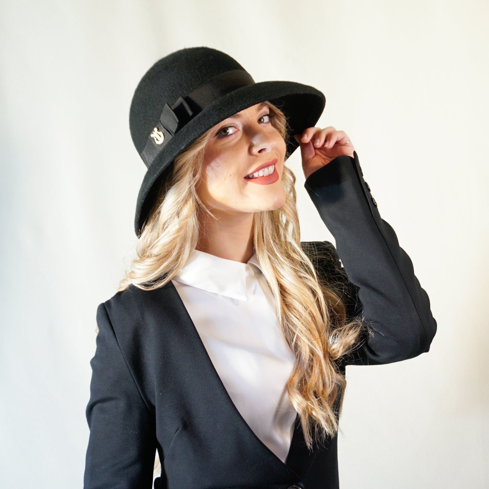 Noir Elegance Hat in Wool Felt with Bow and Gold Lyre by Anna Xaniotaki - three-quarter front right view