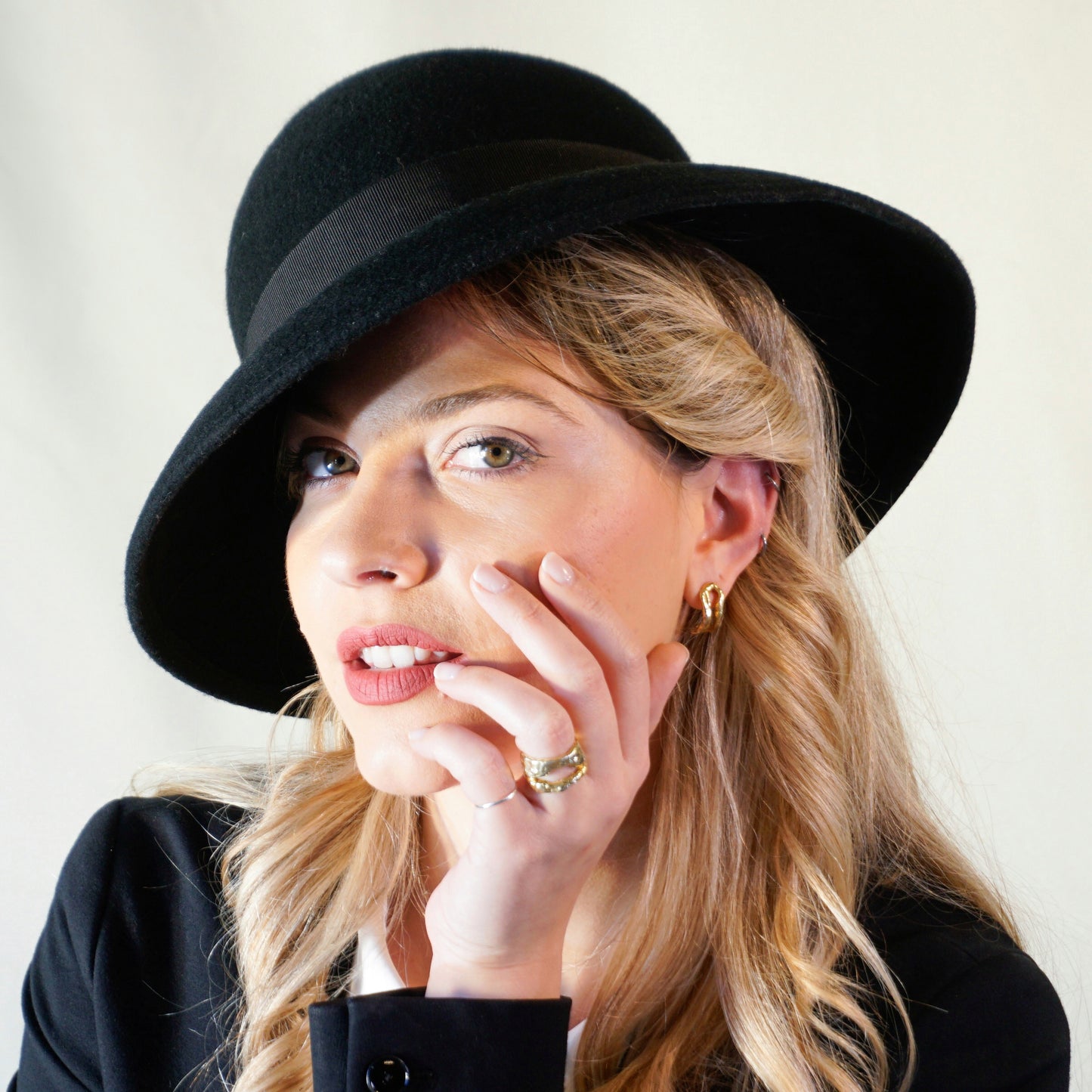 Noir Elegance Classic Hat in Wool Felt with Bow and Gold Lyre by Anna Xaniotaki - three-quarter front left view