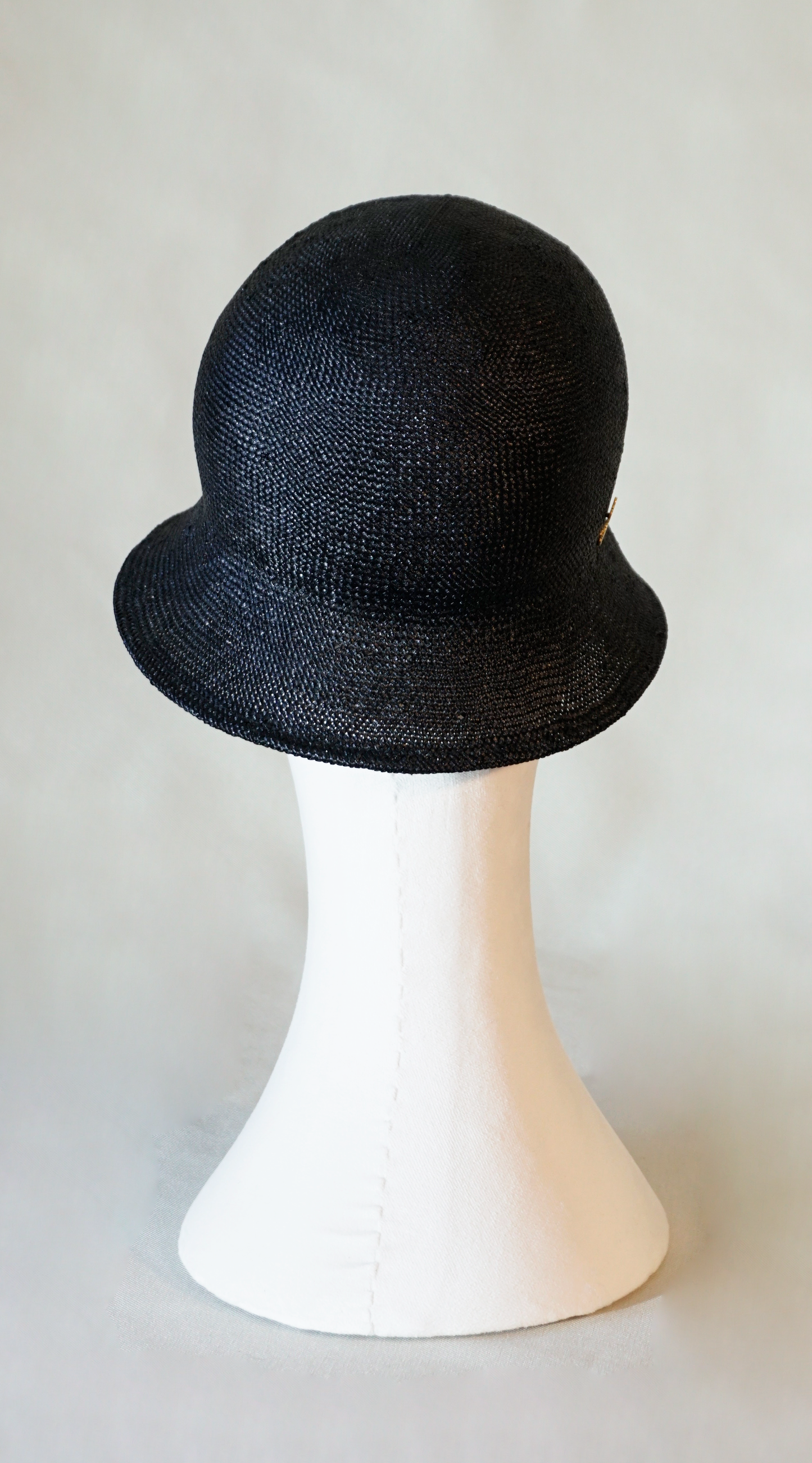 Nyx Cloche Hat in Visca Straw in Black with a Gold Lyre by Anna Xaniotaki, back view