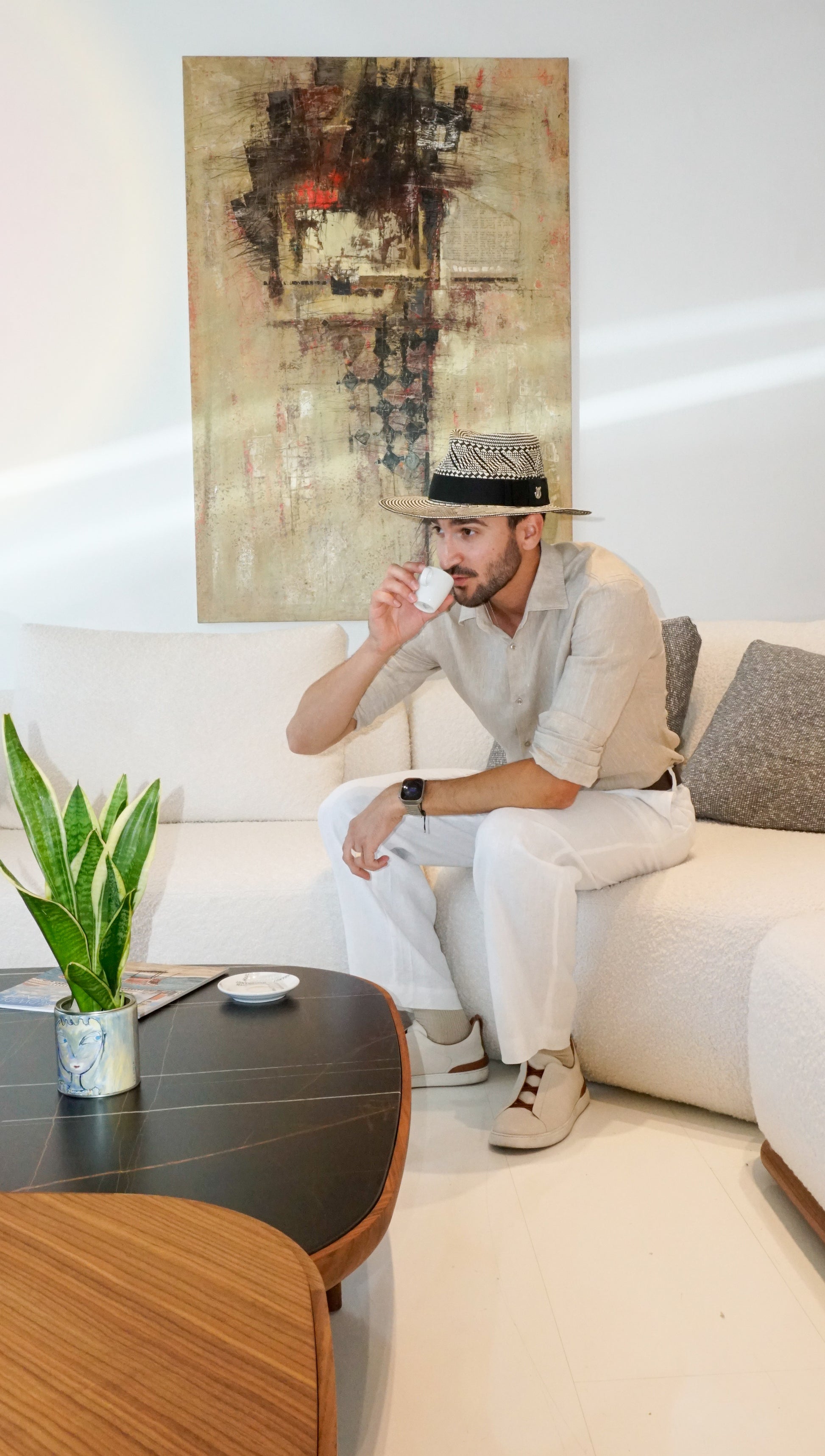 As seen on. Man wearing the Odysseus Fedora in luxury straw, black and light cream, with black Italian cotton grosgrain ribbon and 925 sterling silver jewel by Anna Xaniotaki ATHENA