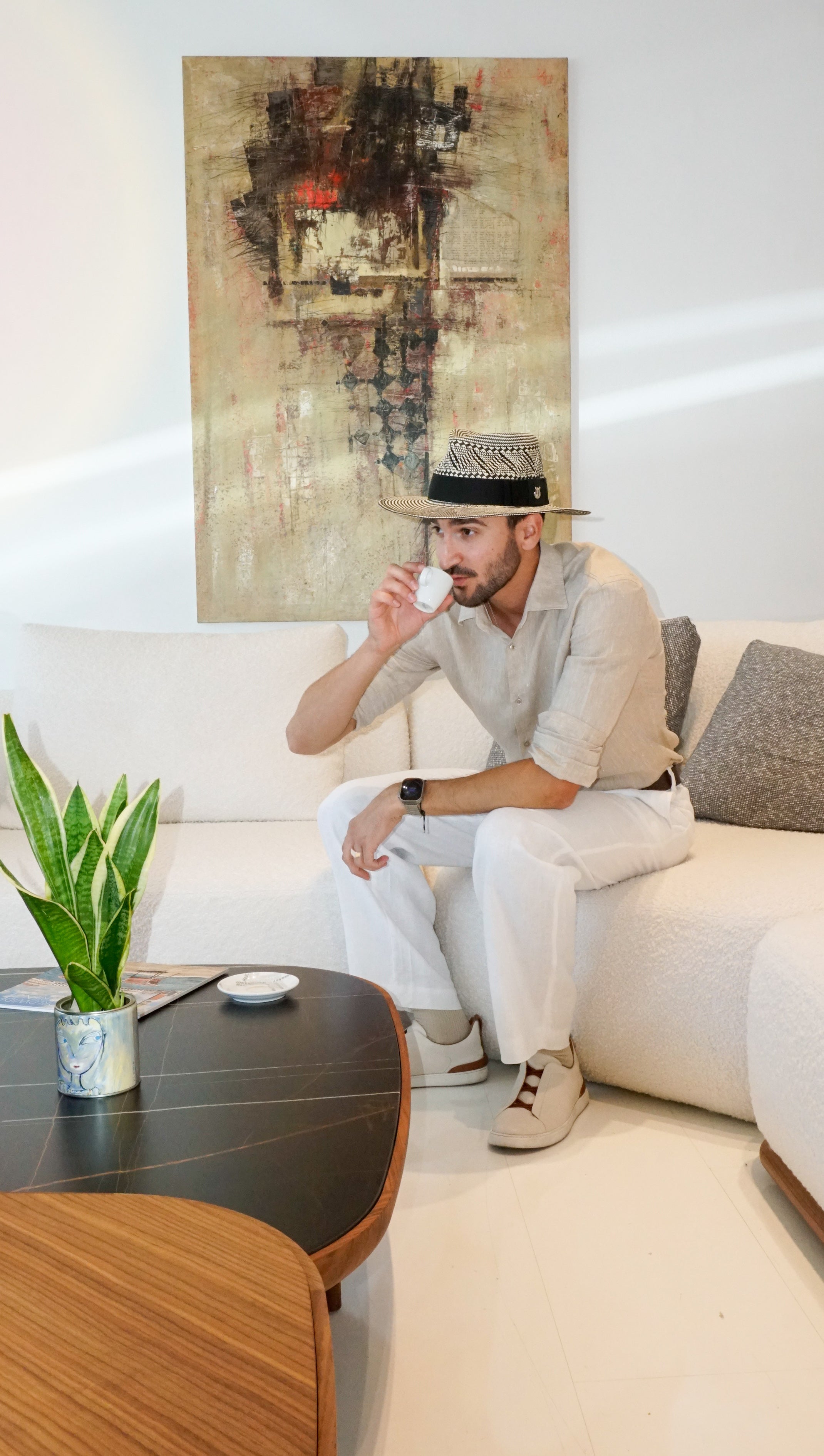 As seen on. Man wearing the Odysseus Fedora in luxury straw, black and light cream, with black Italian cotton grosgrain ribbon and 925 sterling silver jewel by Anna Xaniotaki ATHENA