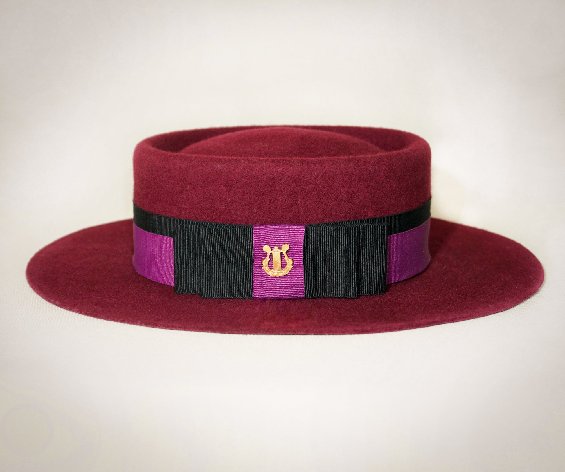 Double bow detail with black and orchid purple grosgrain ribbons on Scarlet Ode burgundy boater  
by Anna Xaniotaki