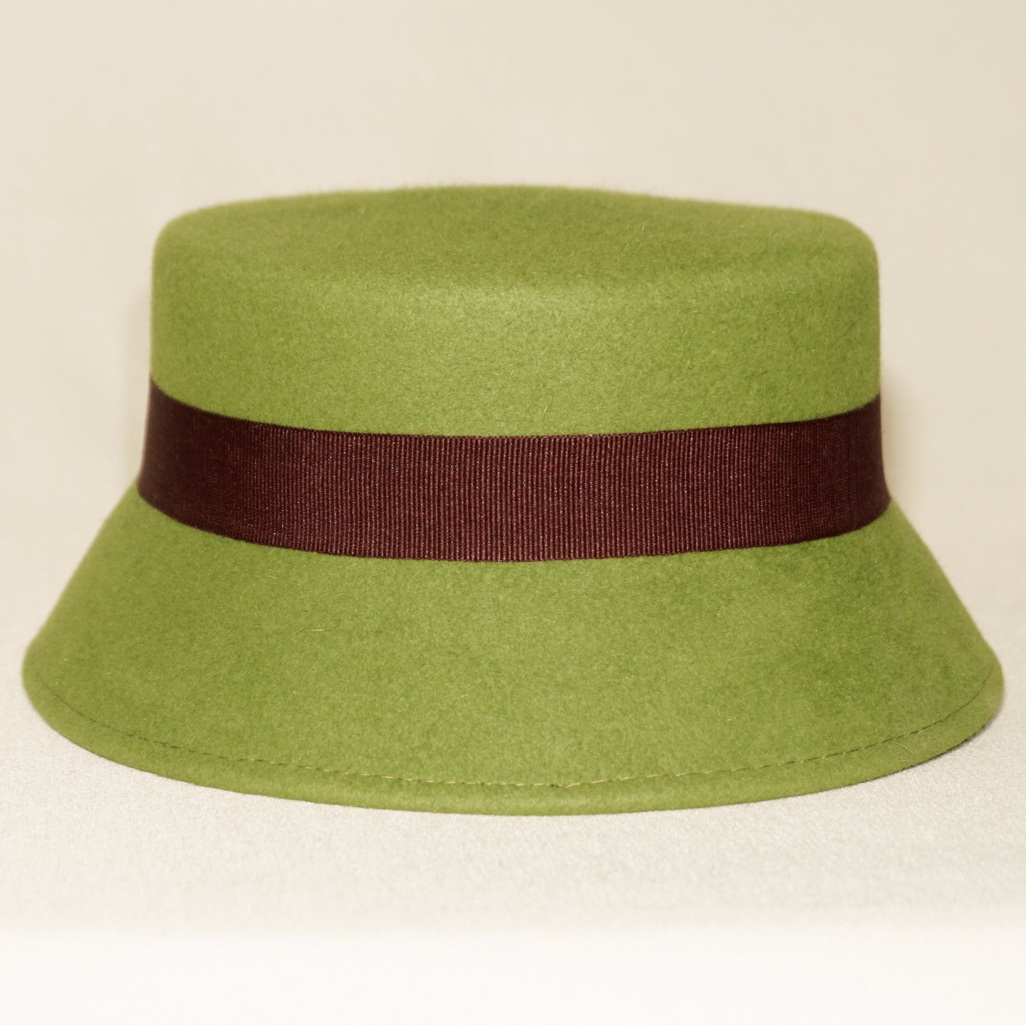 Aristocratic Melody lime pillbox felt hat with double burgundy bow and 14ct gold-plated silver lyre by Anna Xaniotaki - back view
